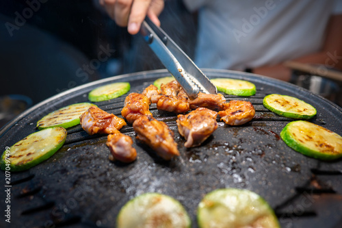 Grilling Chicken and Vegetables on a Korean BBQ Table with Steam