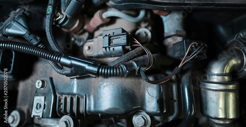 Automotive engine sensor connector and wiring harness close up, vehicle electronics and engine management system component