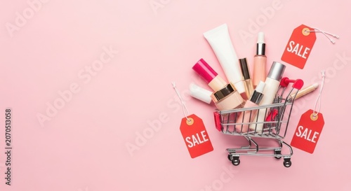 Miniature shopping cart filled with luxury beauty cosmetics and a sale tag, perfect for retail promotions.