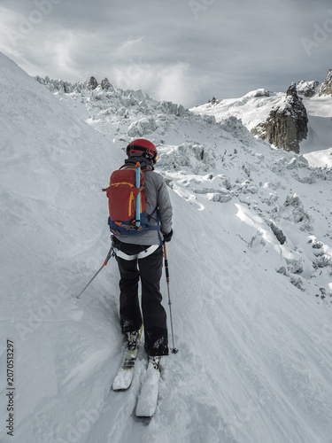 Single female skier overlooking Glacier du Geant in the Mont Blanc massif