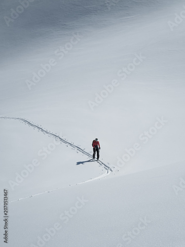 Single female skier touring in the backcountry in Chamonix France
