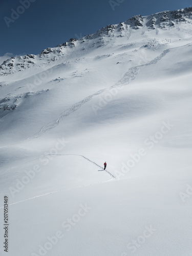 Single female skier touring in the backcountry in Chamonix France
