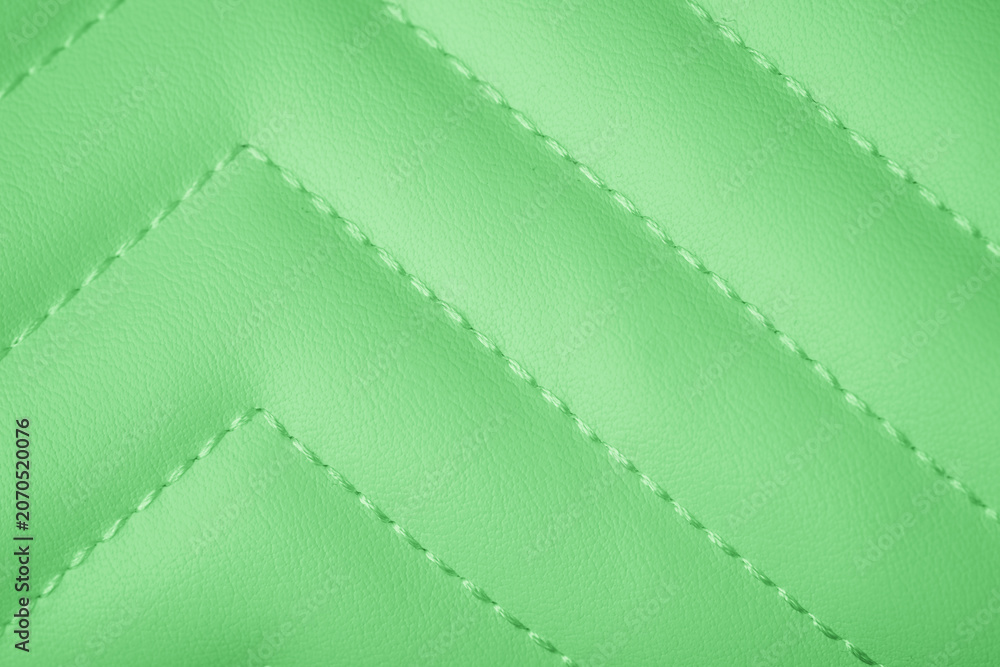 Naklejka premium Vibrant lime green quilted artificial leather material surface with precise diagonal stitching