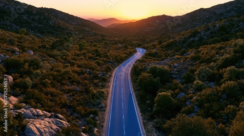 Winding road through hilly terrain at sunset