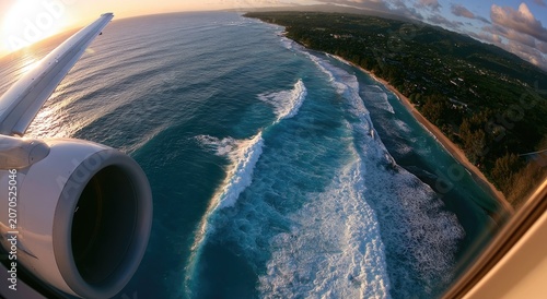 Aerial view of ocean waves crashing on a tropical coast from airplane window