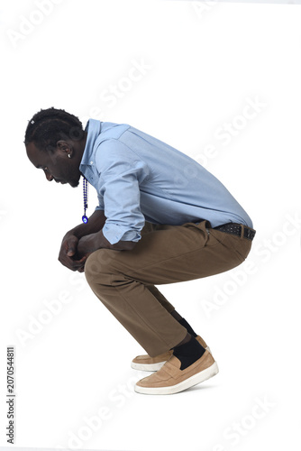 side view of a man squatting  on white background