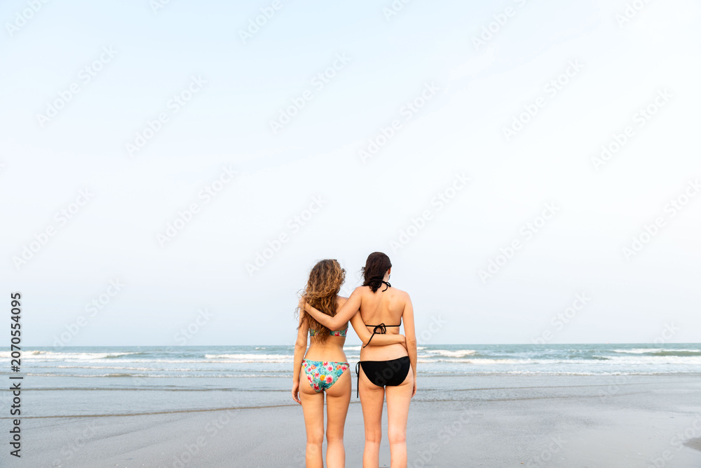 Fototapeta premium Friends enjoying serene beach view.