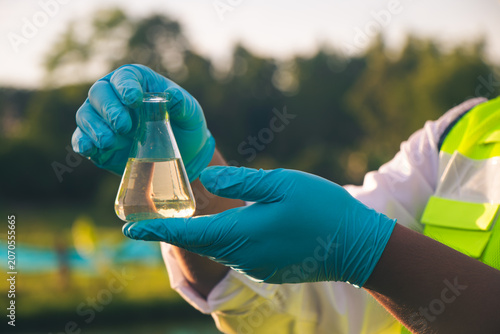 Research specialist performing chemical analysis on water samples to support environmental conservation efforts.