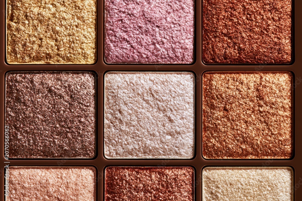 Fototapeta premium Shimmering metallic eyeshadow palette in gold, bronze and pink cosmetic shades