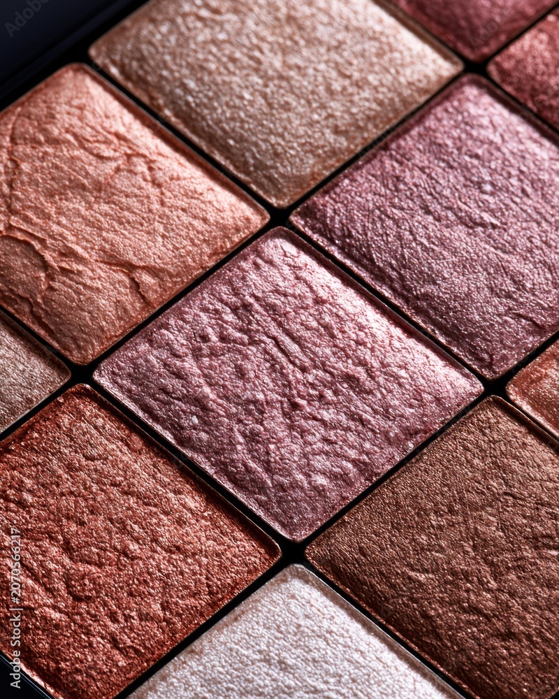 Fototapeta premium Macro texture of metallic pink and bronze eyeshadow pans in luxury cosmetic palette