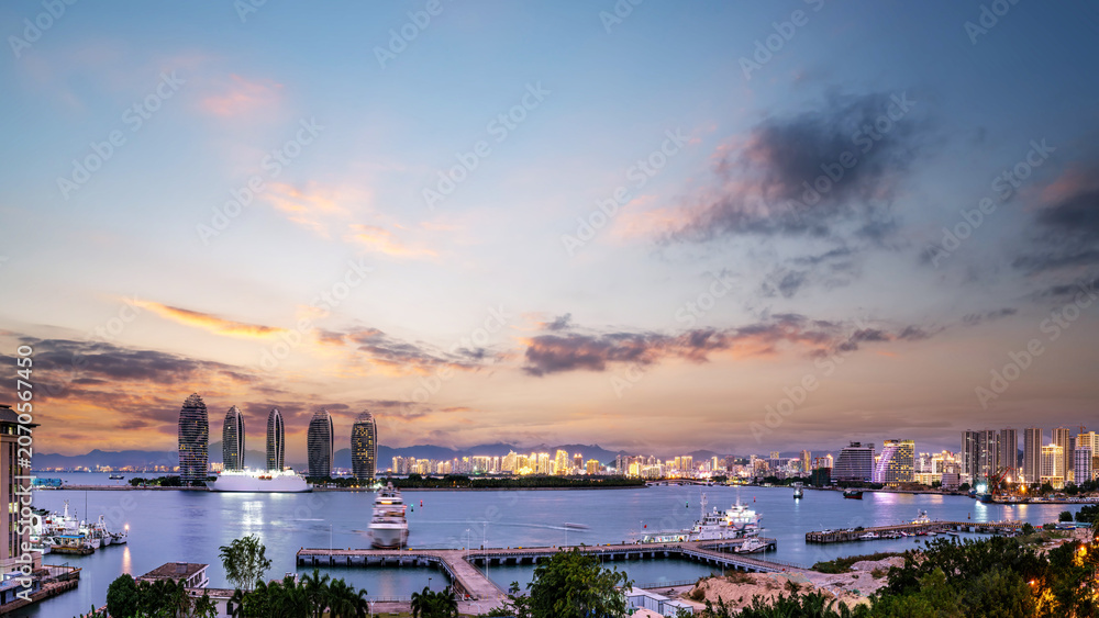Fototapeta premium Twilight Coastal Cityscape with Yachts and Modern Towers