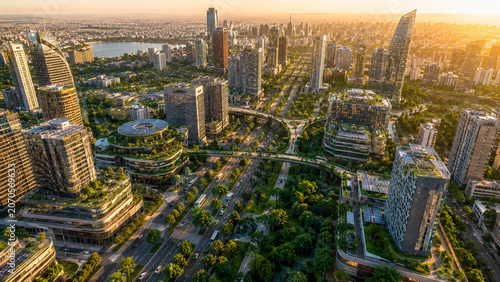 Aerial View of Futuristic Green Smart City with Solar Rooftops and Sustainable Architecture at Golden Hour