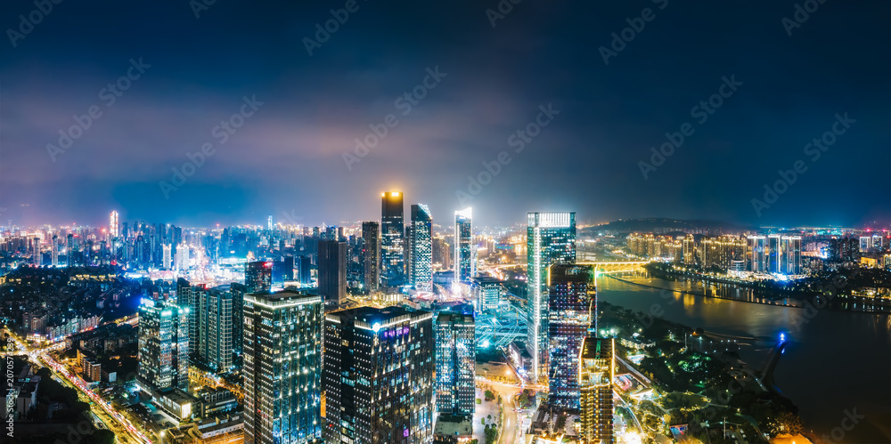 Obraz premium Panoramic Night View of Modern Urban Skyline with River