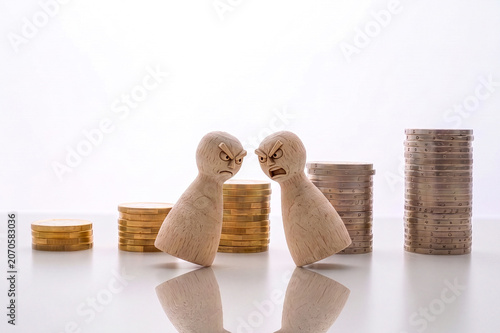 Two opposing pawns facing each other with growing coin stacks, symbolizing financial conflict, rivalry, inequality and economic tension.