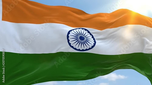 Vibrant Indian flag waving majestically against a bright blue sky with sun flares