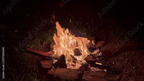 Bonfire flaming at night in winter , atmospheric horizontal video	