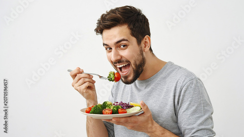 young man eating salad