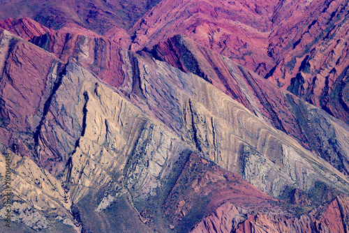 Fotografía A dramatic view of vividly colored, folded Andean mountains, revealing exquisite rock layers and dramatic stratification