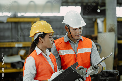 Professional Engineer working woman talking with plant supervisor head for factory auditor inspects