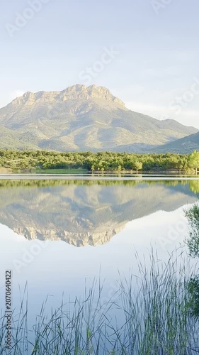 Tranquil Mountain Escape: Crystal Clear Lake with Forest and Peak Views