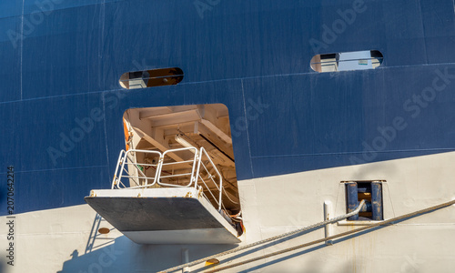фотографія Details of a ship docked at a port with a gangway visible on a sunny day in a bu