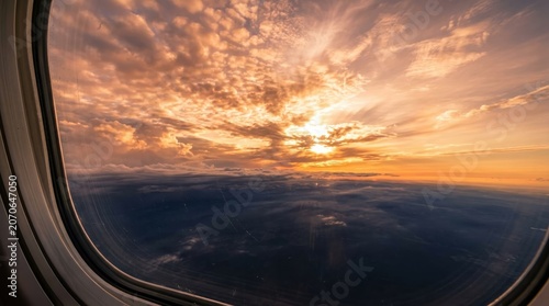 Stunning aerial view of a golden sunset through an airplane window