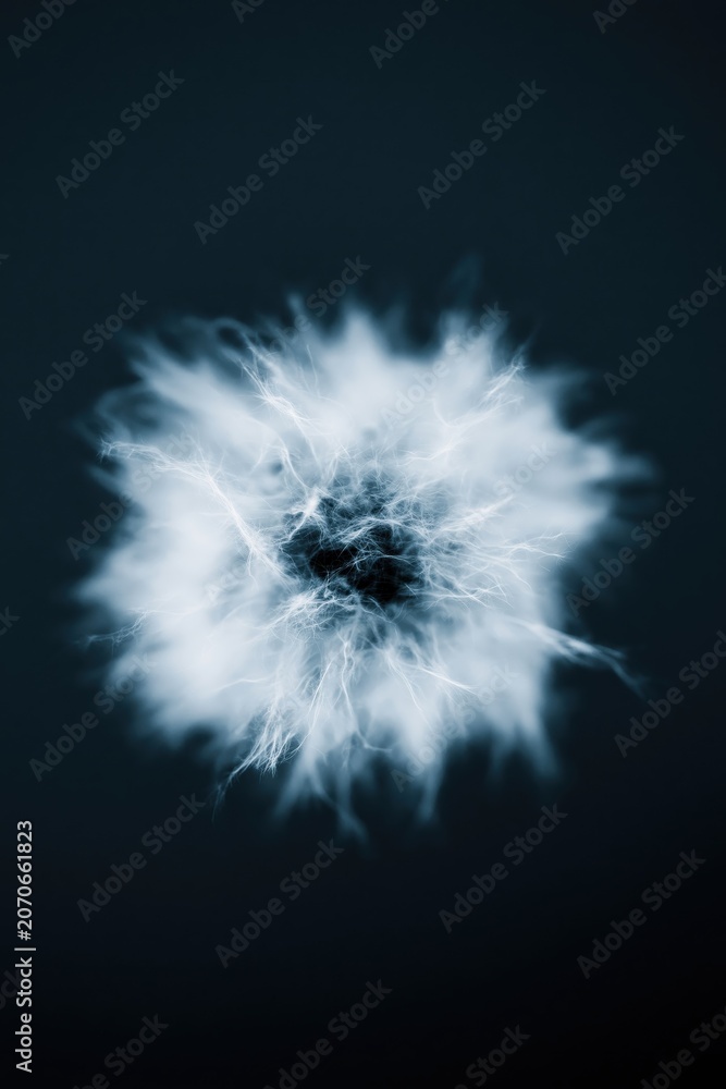 Fototapeta premium Visual display of a cloud of energy with various shades swirling in a dark background during a nighttime setting