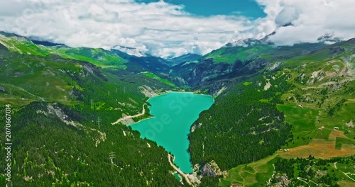 A Swiss lake with clear turquoise water. Establishing shot of Switzerland. Aerial view of Swiss