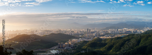 Foto Panoramic valley and city sprawl under clear midday sky Sanya, Hainan Island, Ch