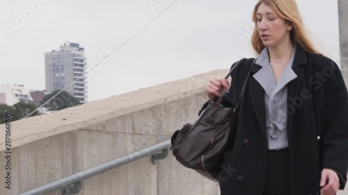 Young businesswoman walking down concrete stairs in the city