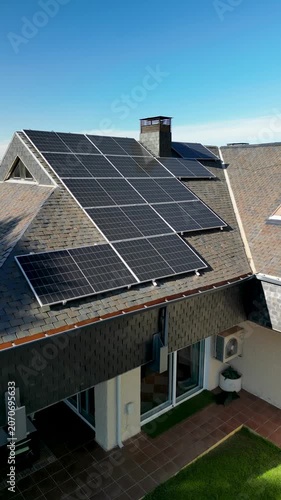 Solar panels providing sustainable energy on a residential house roof.Vertical video