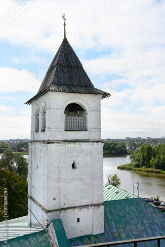 Medieval brick tower with wooden roof and weather vane in Yaroslavl, Russia