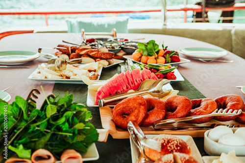 traditional turkish breakfast feast with rich variety on table served on boat gulette for holiday tourists