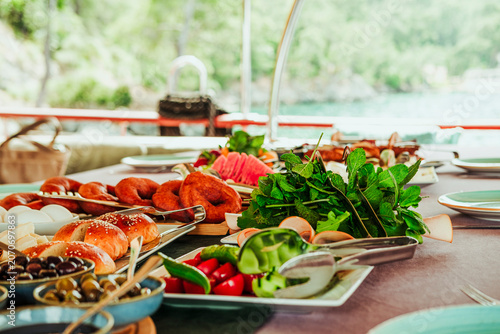 traditional turkish breakfast feast with rich variety on table served on boat gulette for holiday tourists