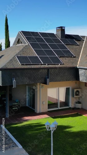 Aerial view of a modern home with solar panels on the roof.Vertical video