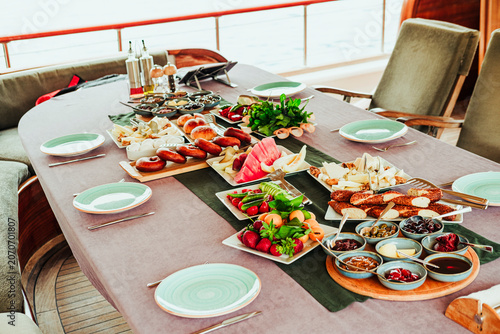 traditional turkish breakfast feast with rich variety on table served on boat gulette for holiday tourists