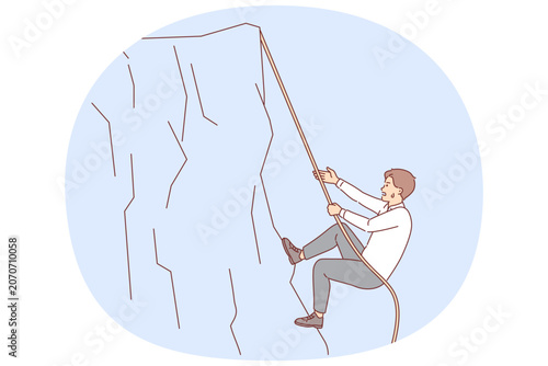 Schilderij op canvas Business man climbs up cliff, taking on difficult challenge, does not stop tryin