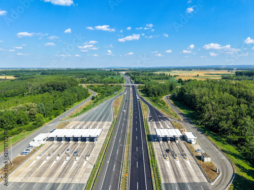 Highway infrastructure and toll gates from above with clear blue sky