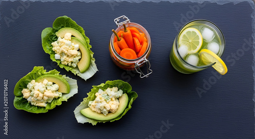 Healthy food arrangement with salad, avocado, and lemonade