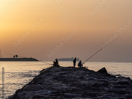 Fishermen on Pinedo beach (Valencia, Spain) at dawn