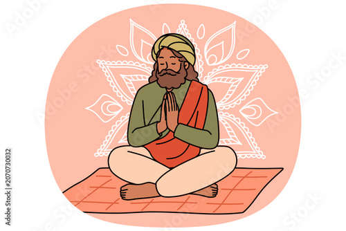 Fotografie Meditating Indian man fakir prays sitting on mat with mandala sign behind back