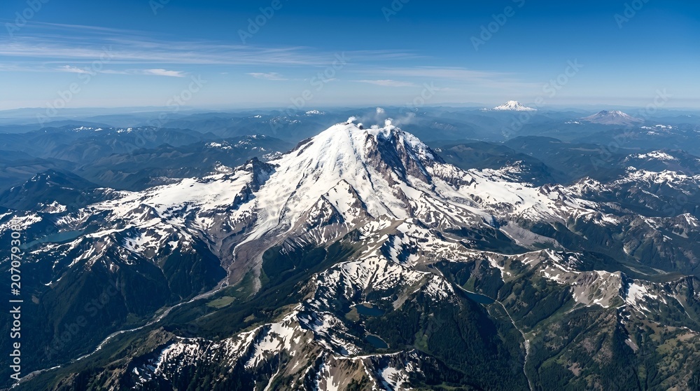 Obraz premium Majestic Snow-Capped Volcano Summit Against Blue Sky