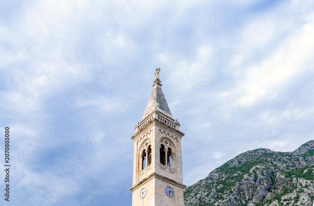 Fototapeta premium Ancient mediterranean campanile and mountain landscape, stone church bell tower