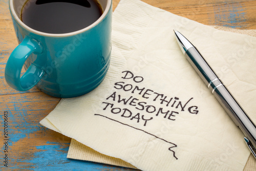 do something awesome today - inspirational handwriting on a napkin with a cup of coffee