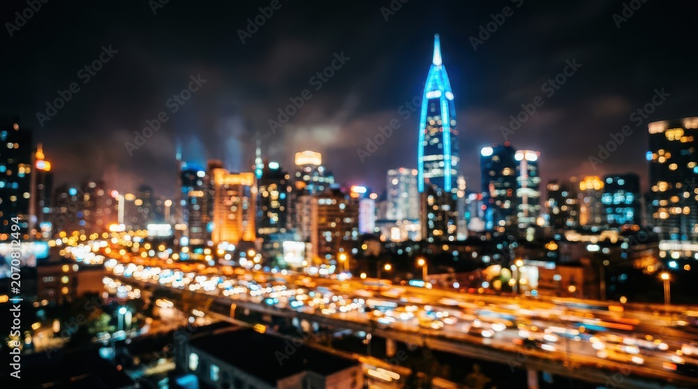 Fototapeta premium Blurry Nighttime Cityscape with Traffic and Illuminated Skyscrapers urban