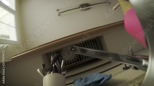 Dripping kitchen faucet seen from underneath