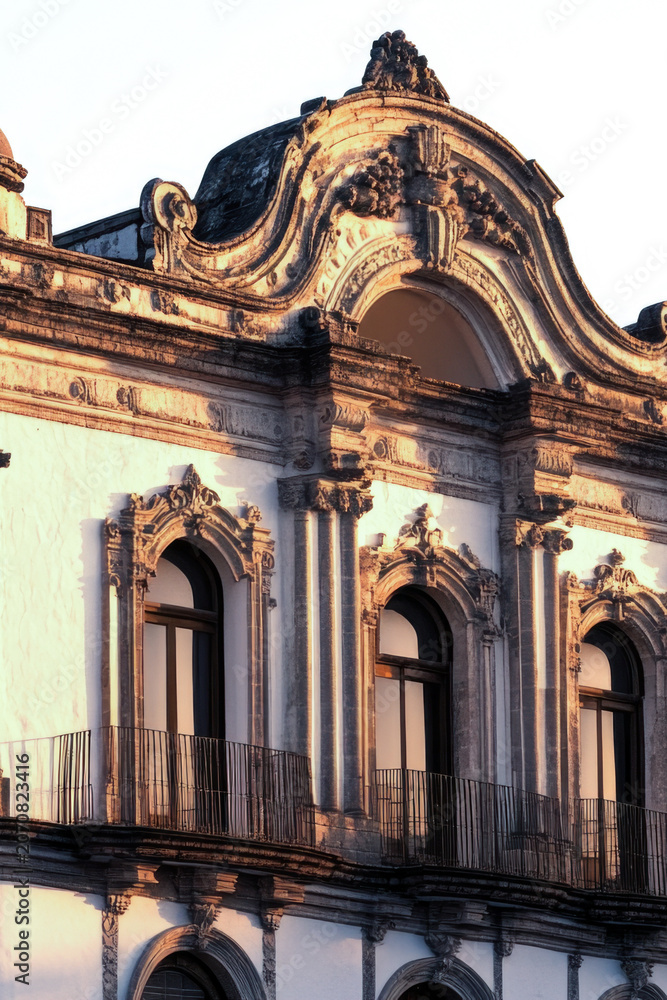 Fototapeta premium A large city hall building with a clock tower, suitable for use in urban or architectural settings vertical frame