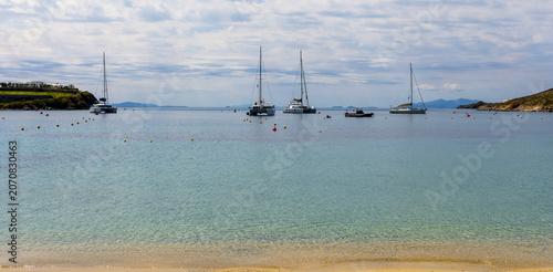 Photography Scenic view of Ornos Beach in Mykonos, Greece, a major stop-over and anchoring point for private yachts and catamarans