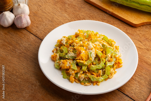 Stir fried Bitter Gourd with Egg in white plate.asian food.