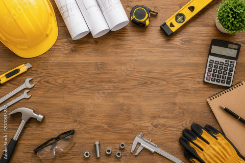 Workers use these tools to plan and build various projects. Items like a hard hat, tape measure, and calipers show the work process. This setup is ideal for construction tasks.